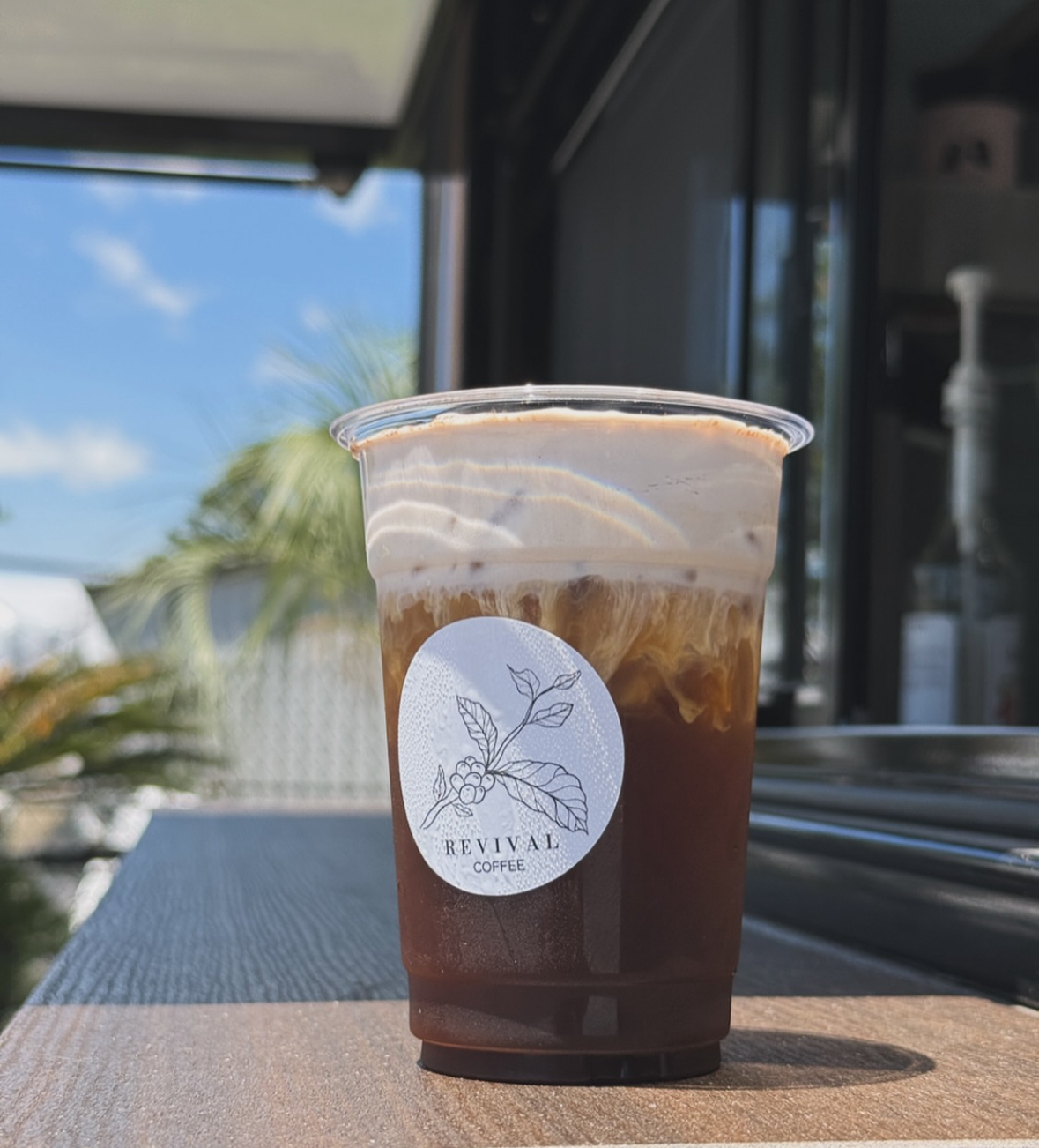 Seasonal coffee topped with whipped cream at Revival Coffee