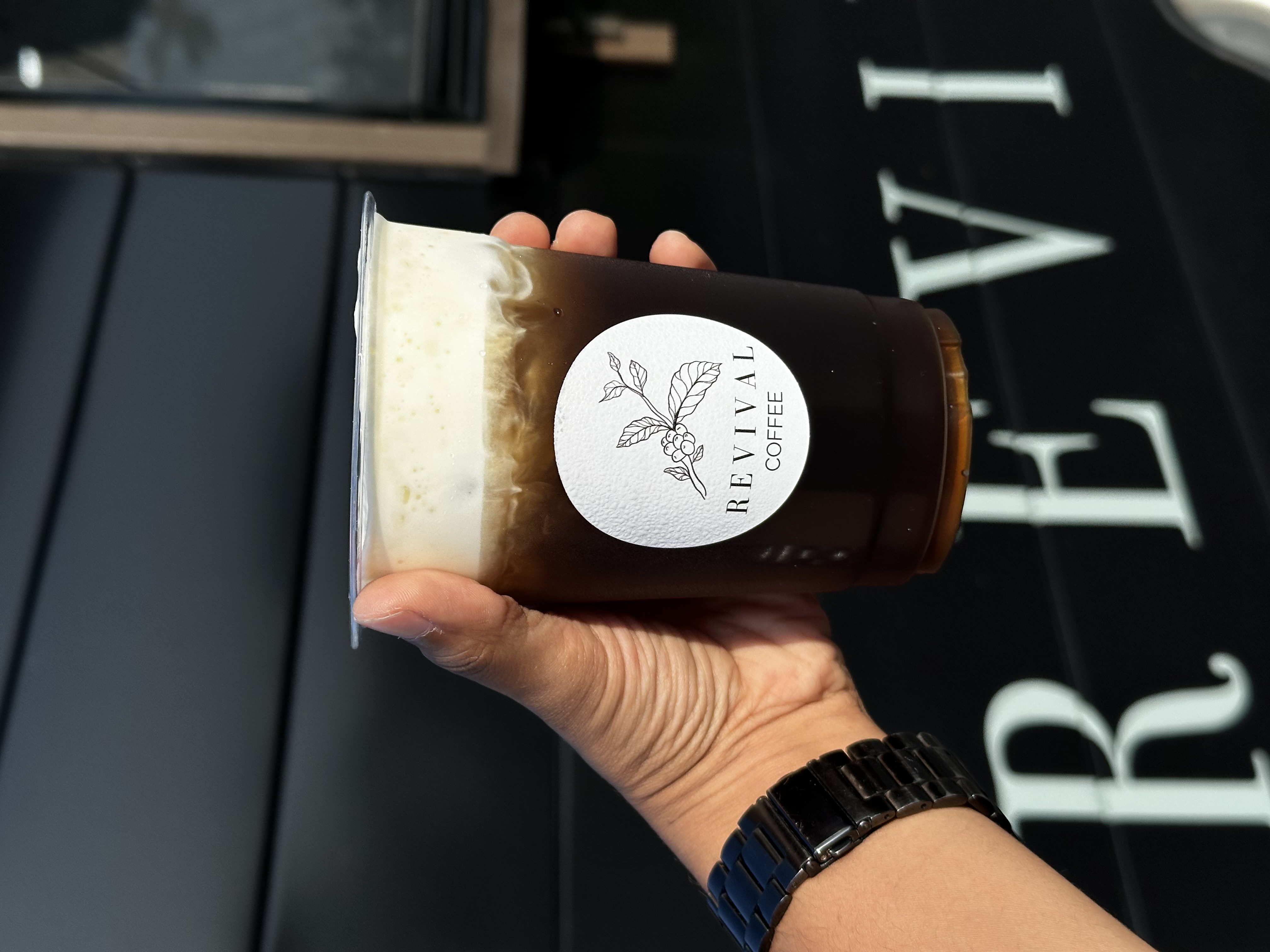 Cold brew coffee in branded cup from Revival Coffee