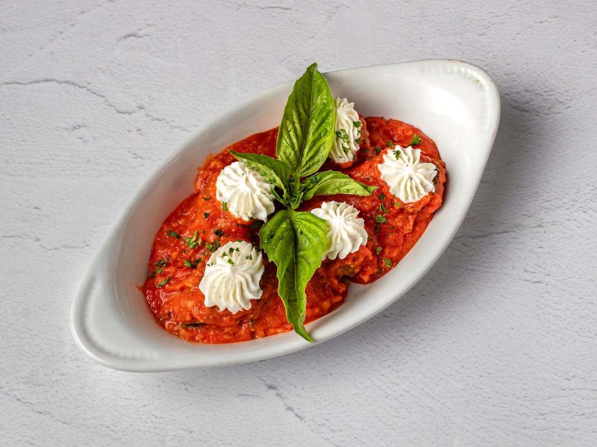 Amici Meatballs with Ricotta in homemade marinara and fresh basil — signature Italian appetizer at Amici Brick Oven Pizza, West Palm Beach