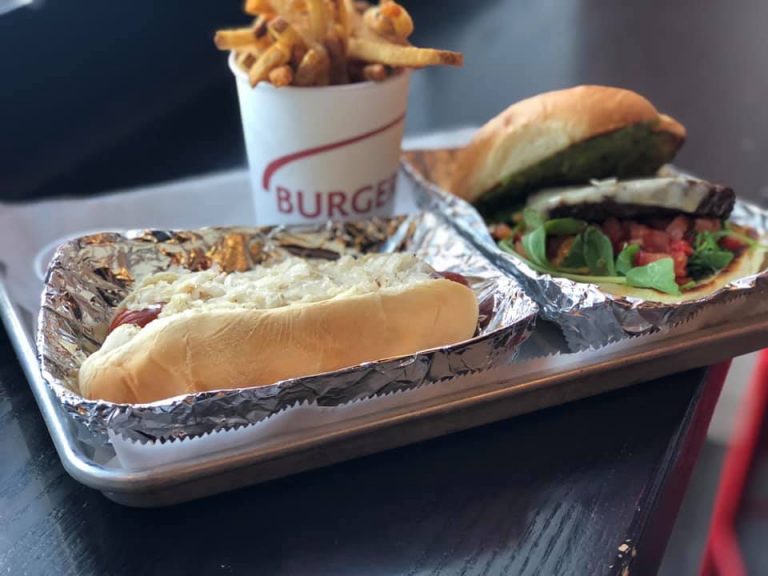 Burger Fresh burger, hot dog, and fries on a tray